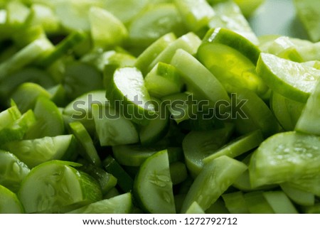 Many chopped cucumber for salad and cooking food, this Fresh Cucumber for mass street food vendor prepare for ready meal, background shadow selective focus