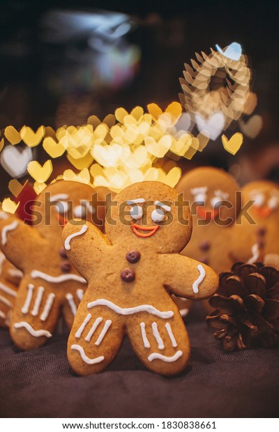 Many Christmas cookies in the form of gingerbread\
men depicting people celebrating the New Year in the forest near\
the Christmas tree