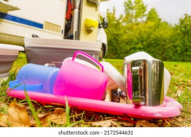 Many Clean Dishes Drying Outdoor Against Camper Vehicle. Washing Up On Fresh Air. Camping On Nature, Dishwashing Outside.