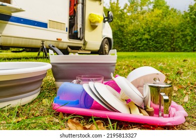 Many Clean Dishes Drying Outdoor Against Camper Vehicle. Washing Up On Fresh Air. Camping On Nature, Dishwashing Outside.