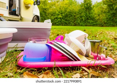 Many Clean Dishes Drying Outdoor Against Camper Vehicle. Washing Up On Fresh Air. Camping On Nature, Dishwashing Outside.