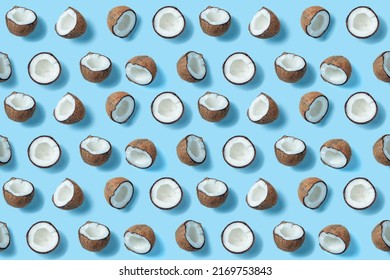 Many coconut halves evenly-chaotically arranged on a blue background. A wallpaper for a desktop of a computer or home screen on a mobile phone. Coconut Pattern
