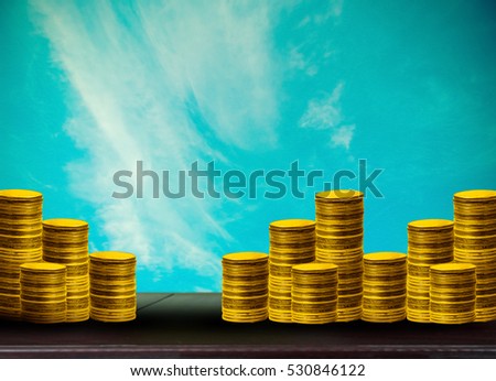 many coins with abstract blurred of sky and sunlight background, investment concepts.