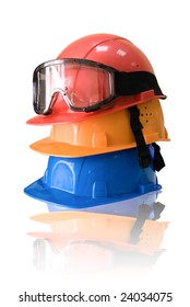 Many colored hardhats and goggles on white