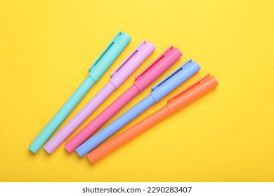 Many colorful markers on yellow background, above view - Shutterstock ID 2290283407