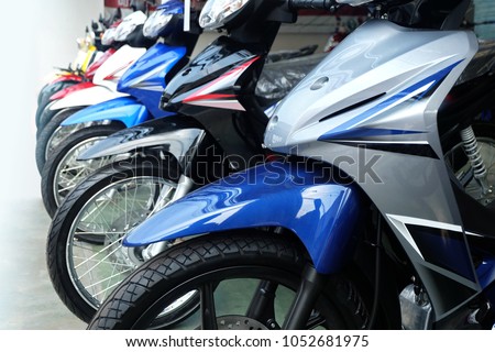 Many colorful motorcycles at the Showroom for sale