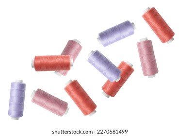 Many colorful sewing threads falling on white background