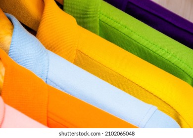 Many Colorful Shirts Hanging On A Rack