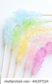 Many colorful sugar crystal candy on wooden stick 