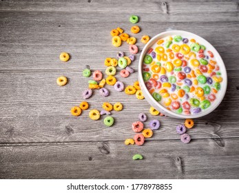 Many Colorful Sugary Cereal Grains On A Blue Background Close-up