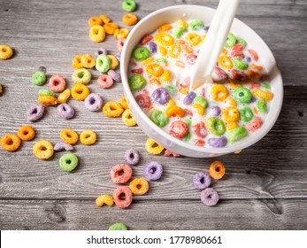 Many Colorful Sugary Cereal Grains On A Blue Background Close-up