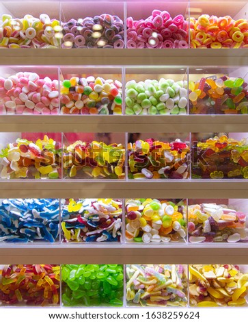 Many colorful sweets on display for pick and mix in a candy shop