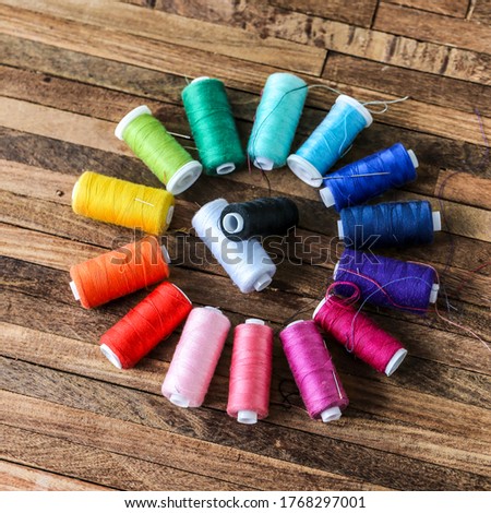 many colorful wire spools on wooden table