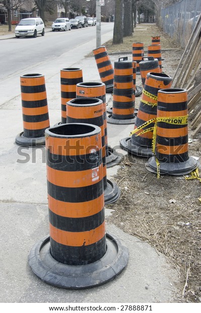 many construction road warning cones /\
industrial background