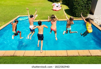 Many Cute Children Jump Into The Swimming Pool About To Dive View From Above