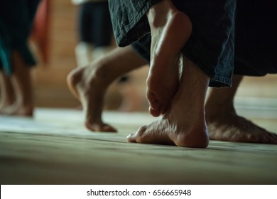 many dancers foots on floor, on blurred background
