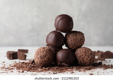 Many delicious chocolate truffles on light table