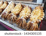 Many delicious grilled giant octopuses that sale on the marble table in local stalls at Jagalchi Market, the famous biggest fish market in Busan City, South Korea.