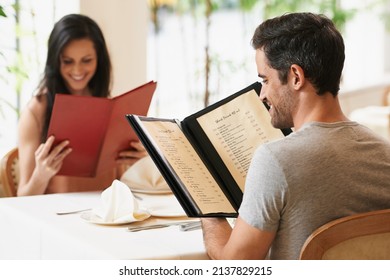 So Many Delicious Things To Choose From. A Happy Young Couple On A Date At A Fancy Restaurant.