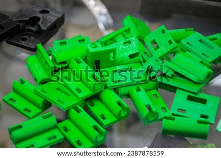 Many details printed on 3D printer from molten plastic green color. Model of part created on 3D printer from green plastic. Concept 3D printer 3D printing modeling prototyping three dimensional object