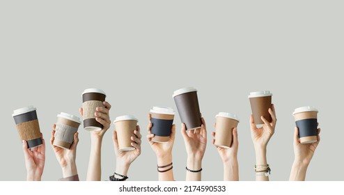 Many different arms raised up holding coffee cup - Shutterstock ID 2174590533