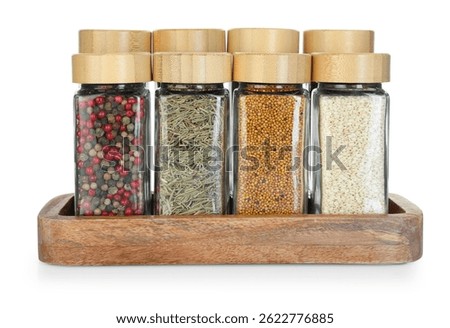 Many different aromatic spices in jars isolated on white