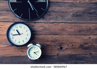 Many Different Clocks On Wooden Table, Copyspace