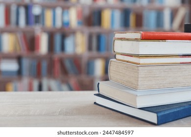 many different colored books, stack of books on wooden table in library, education, library