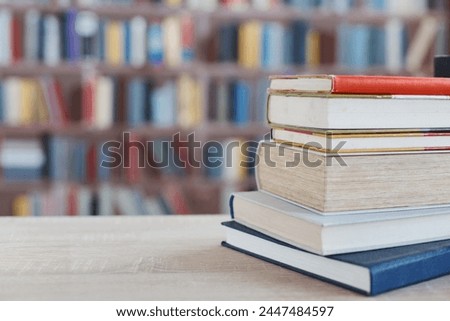 many different colored books, stack of books on wooden table in library, education, library