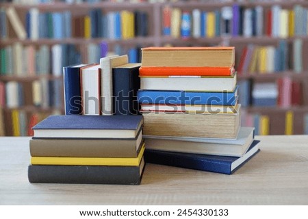 many different colored books, stack of books on wooden table in library, education, library