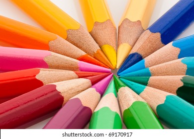 Many different colored pencils on white background