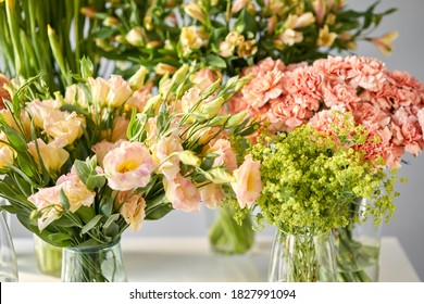 Many different colors on the stand or wooden table in the flower shop. Showcase. Background of mix of flowers. Beautiful flowers for catalog or online store.