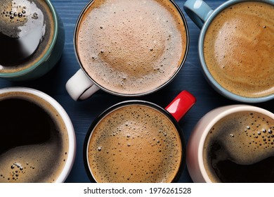 Many different cups of coffee on blue wooden table, flat lay Stockfotó