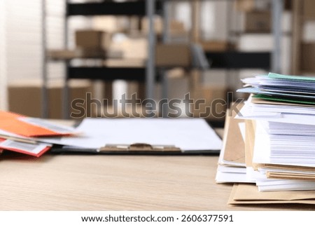 Many different envelopes on table in post office. Space for text