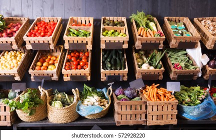 Many Different Fresh Fruits And Vegetables In Baskets On Food Market
