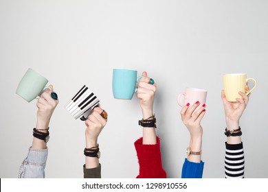 Many Different Hands Holding Coffee Cups