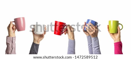 Many different hands holding multi colored cups of coffee on a white background. Female and male hands. Concept of a friendly team, a coffee break, meeting friends, morning in the team. Banner