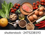 Many different healthy food on dark textured table, flat lay