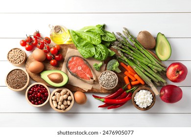 Many different healthy food on white wooden table, flat lay