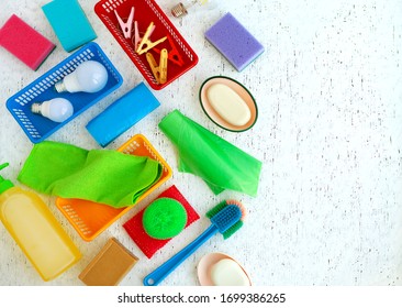 Many different household items  Cleanliness items white texture background  Household items various kinds are arranged in chaotic manner 