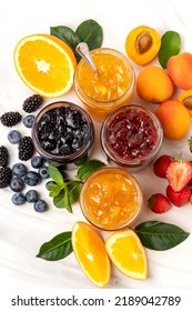 Many different jars of jam  strawberry jam, apricot jam, orange jam, blueberries and blackberries