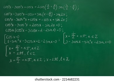 Many different math formulas written on green chalkboard