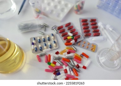 Many different medical pills and drugs with flasks on lab table, top view. Biochemistry and pharmaceutical research in laboratory. - Shutterstock ID 2255819263