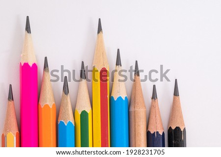 Many different muticolored pencils on white background.Difference concept.