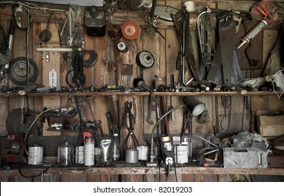 many different old tools hanging on a barn wall - Powered by Shutterstock