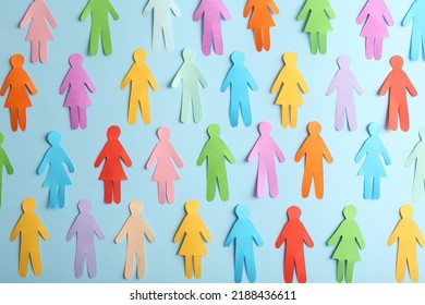 Many different paper human figures on light blue background, flat lay. Diversity and inclusion concept - Powered by Shutterstock