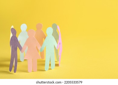 Many different paper human figures standing in circle on yellow background, space for text. Diversity and inclusion concept - Powered by Shutterstock