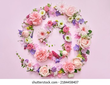 Many different pink lilac violet white pastel flowers mix and green leaves petals spiral on floral background. Blossom composition creative flatlay. Floristic decoration ads. Top view above, flat - Powered by Shutterstock