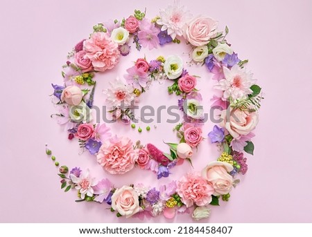 Many different pink lilac violet white pastel flowers mix and green leaves petals spiral on floral background. Blossom composition creative flatlay. Floristic decoration ads. Top view above, flat