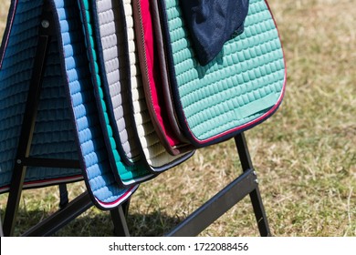 Many Different Saddle Pads At A Tournament